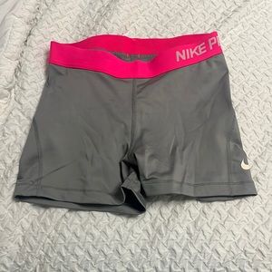 Gray Nike pros with hot pink band in a size small